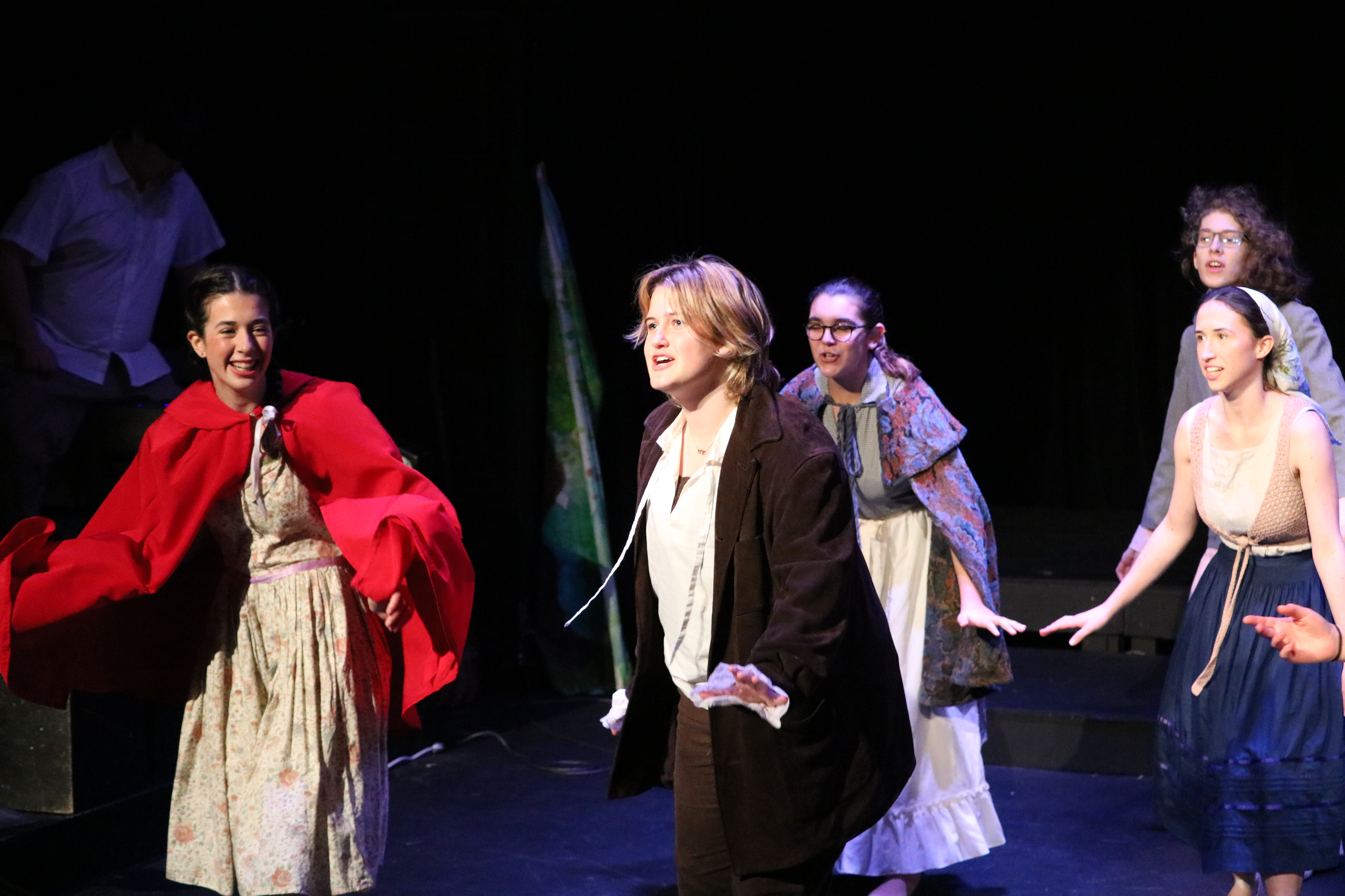 NPA high school students perform the play Into the Woods in costumes.